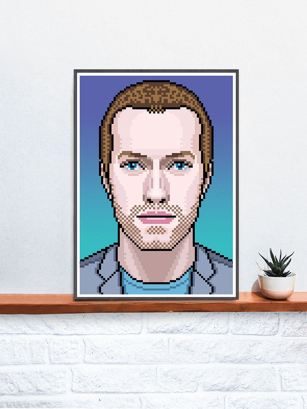 Chris Coldplay Art Print in a frame on a shelf
