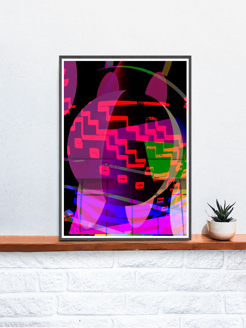 Orbitek Glitch Art Poster in a frame on a shelf